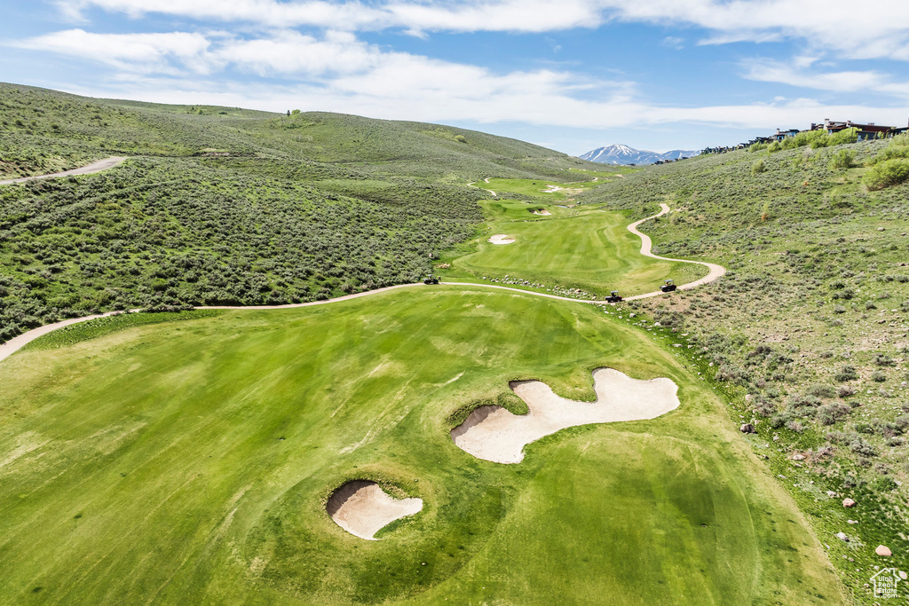 View of property location with a mountainous background and a golf club