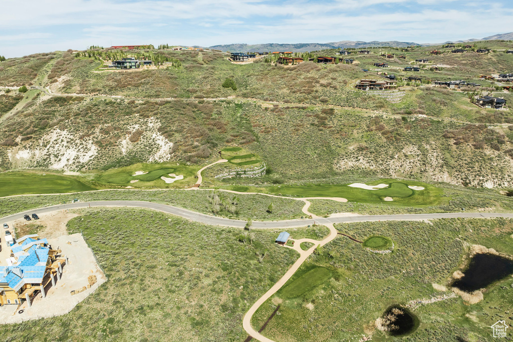 Aerial overview of property\\\'s location with a mountainous background and a golf club