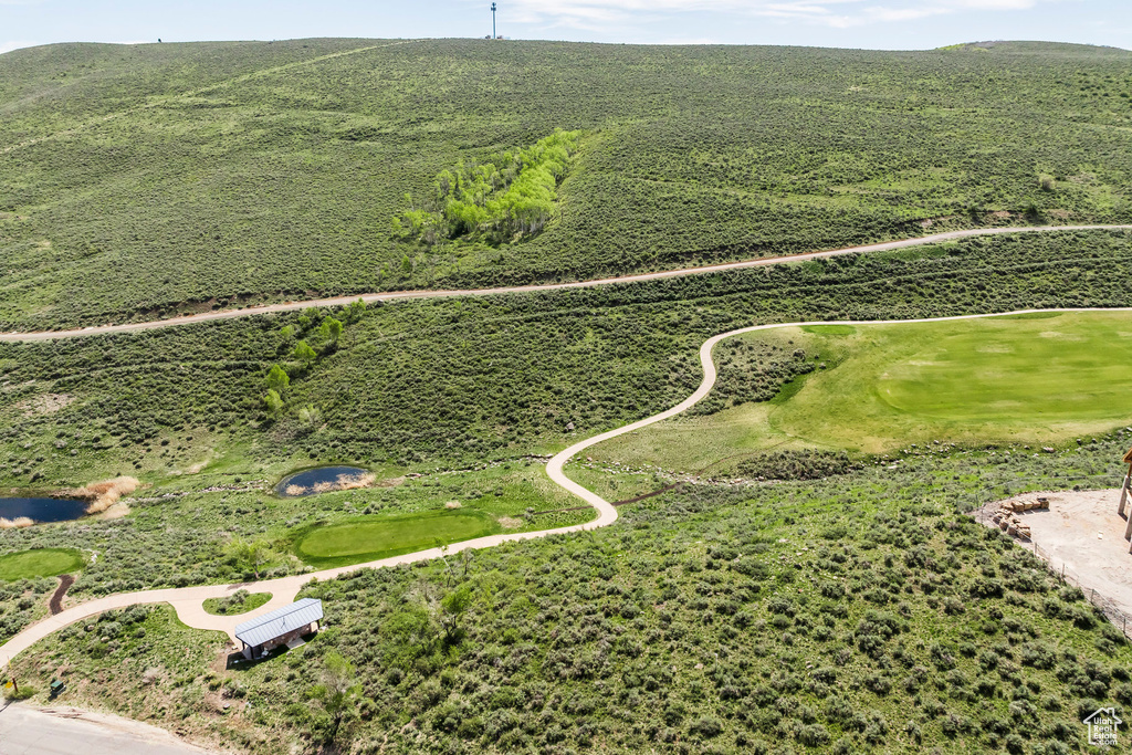 Aerial view of a golf course and a mountain backdrop