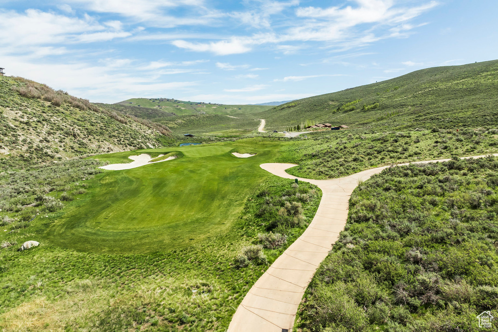 Surrounding community with a mountain view and view of golf course