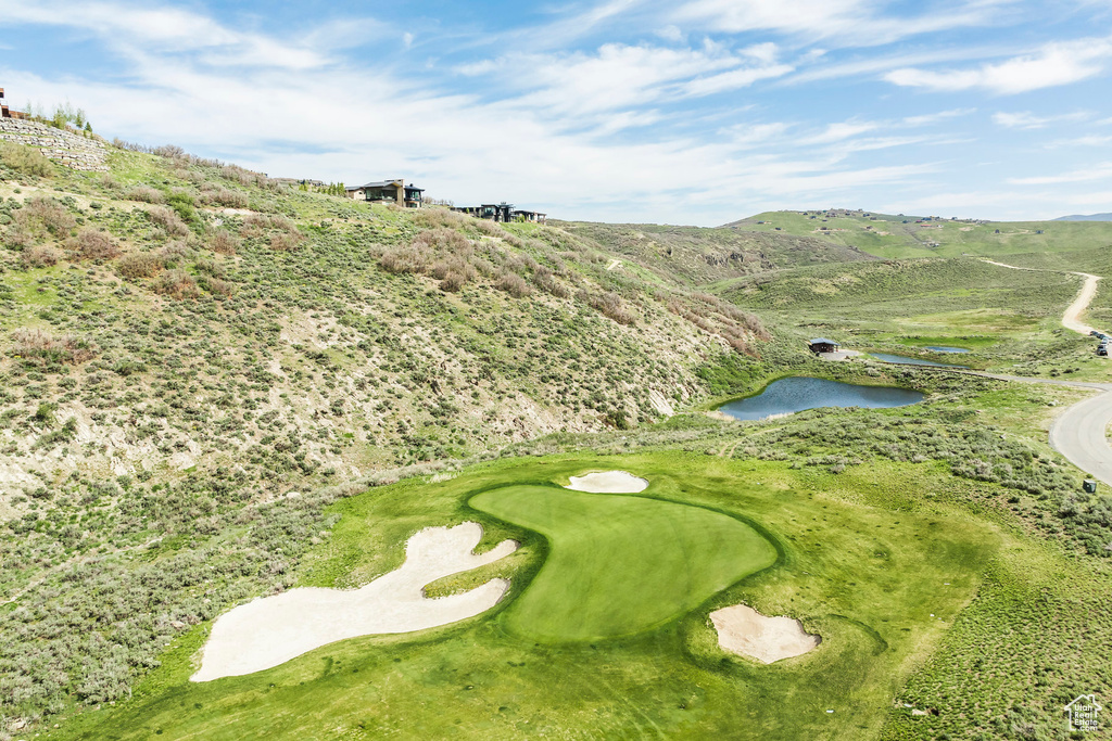 View of community with view of golf course and a water and mountain view
