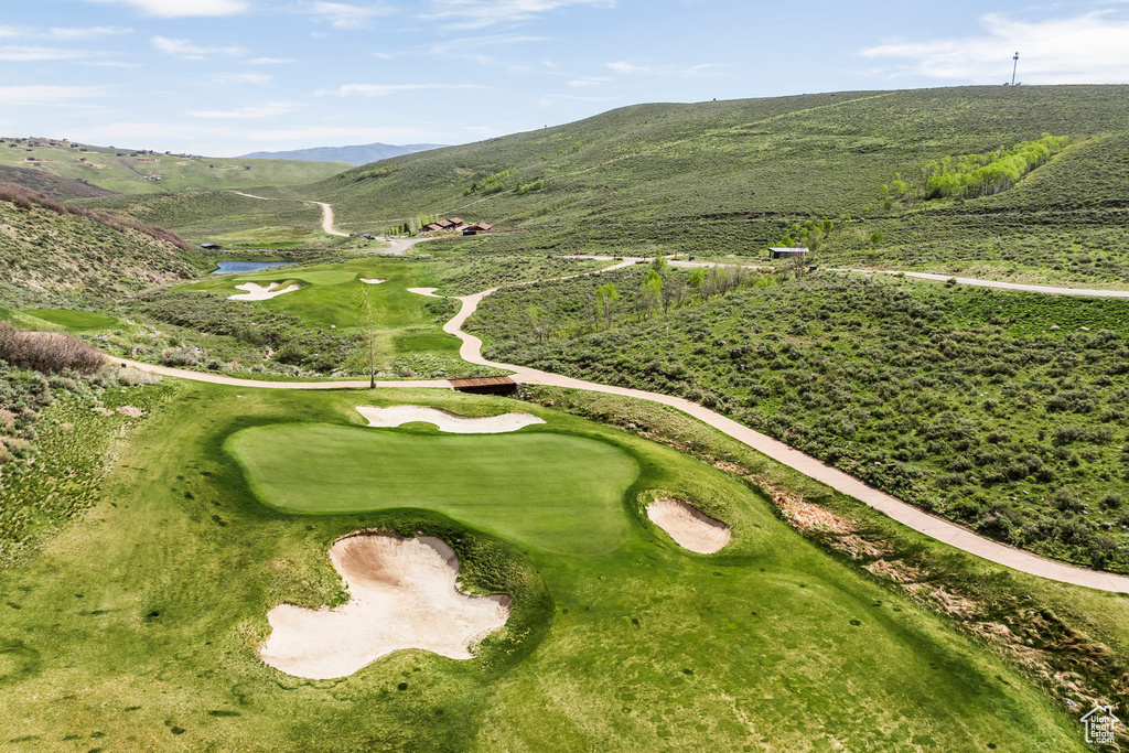 Aerial view of property\\\'s location featuring a golf club and a water and mountain view