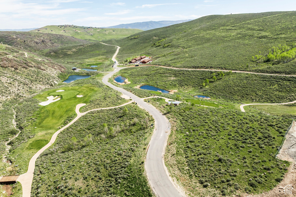 View of property location with a water and mountain view and a local golf course