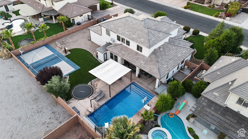 Aerial perspective of suburban area featuring a pool