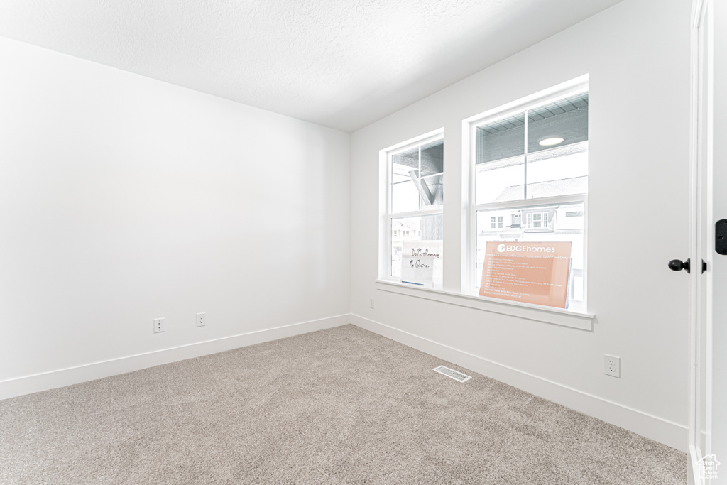 Unfurnished room with carpet and baseboards