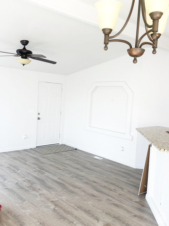 Interior space featuring ceiling fan, baseboards, and wood finished floors