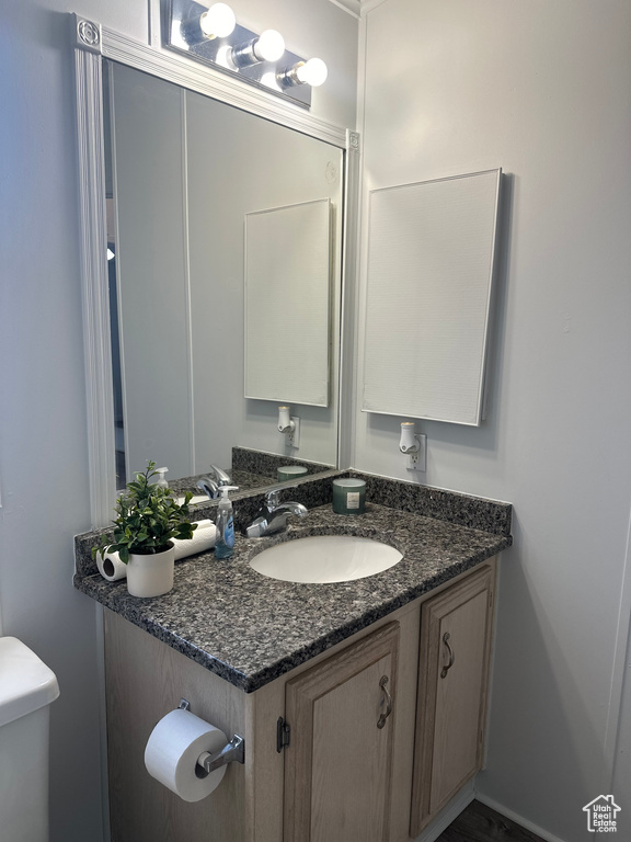 Half bath with vanity and toilet