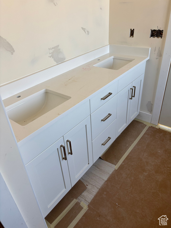 Interior space featuring light countertops, a sink, and white cabinetry