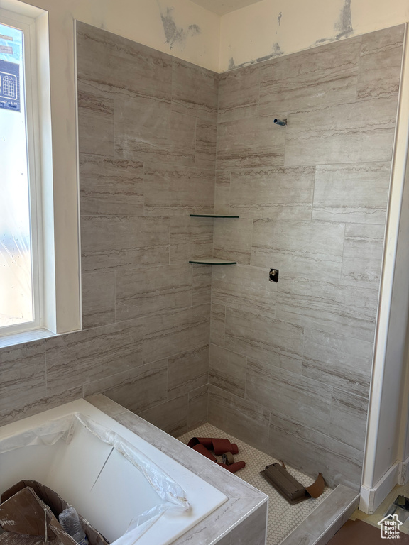 Bathroom with a bath and tiled shower