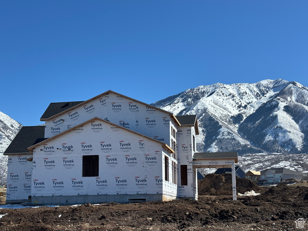 View of side of home with a mountain view