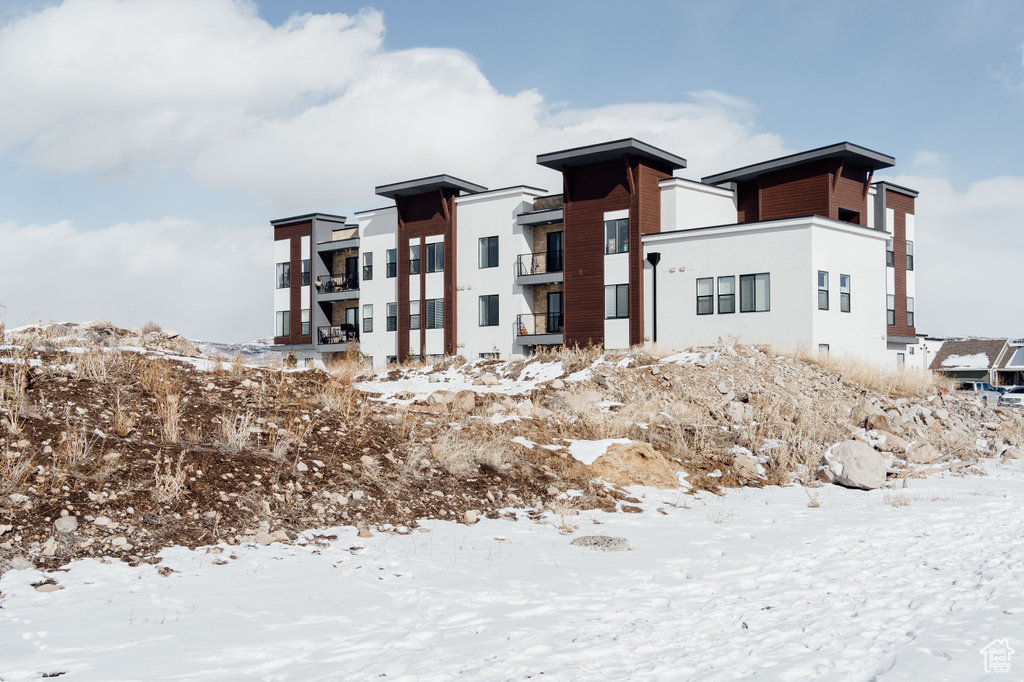 Snow covered property featuring a garage