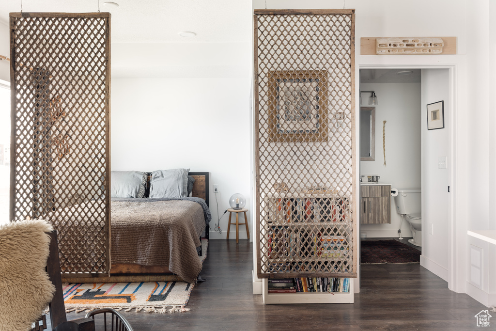 Bedroom featuring dark wood-style flooring and baseboards