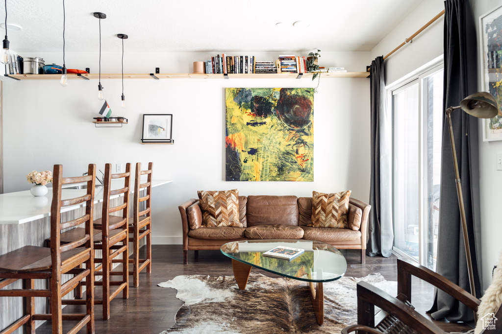 Living room with dark wood finished floors and baseboards