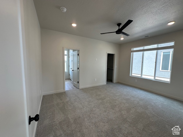 Unfurnished bedroom featuring carpet flooring, recessed lighting, a textured ceiling, and ceiling fan