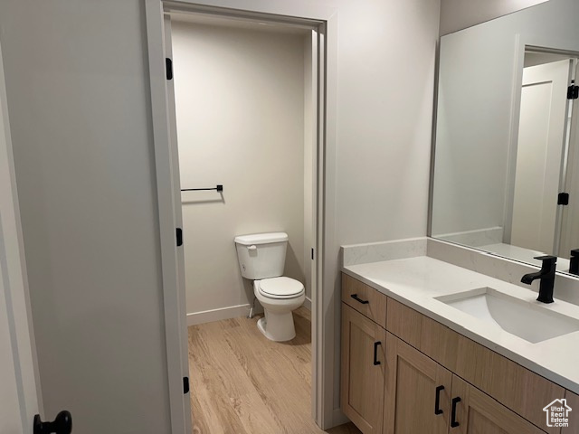 Bathroom with vanity and wood finished floors