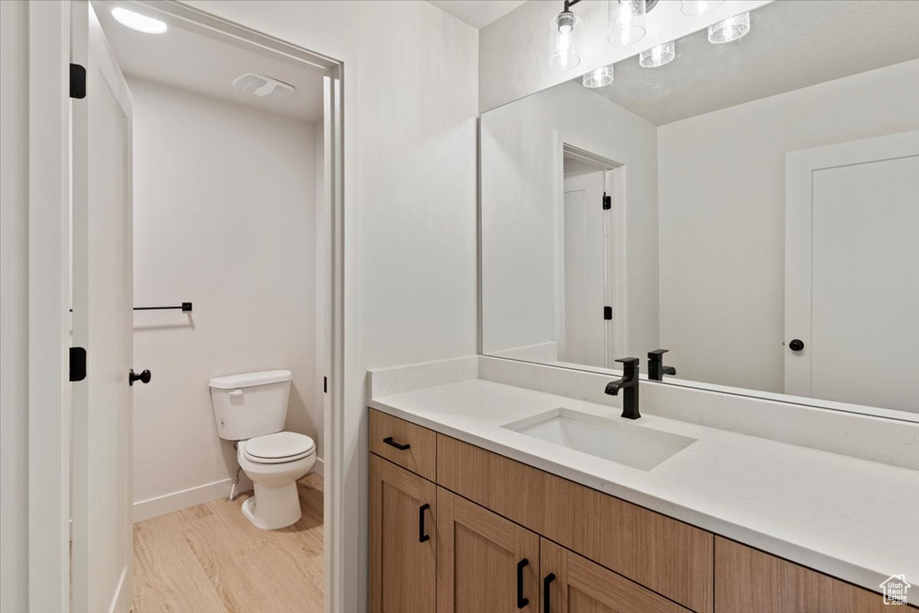 Bathroom with vanity and wood finished floors