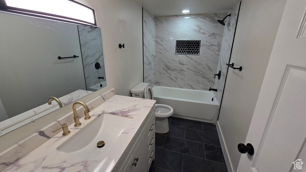 Full bathroom featuring toilet, recessed lighting, vanity, baseboards, and washtub / shower combination