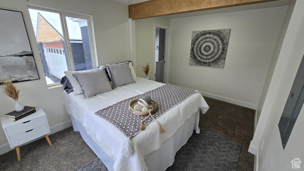 Bedroom with baseboards and dark carpet