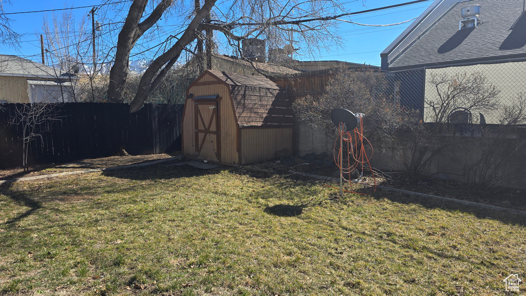 View of yard with an outbuilding, a shed, and a fenced backyard