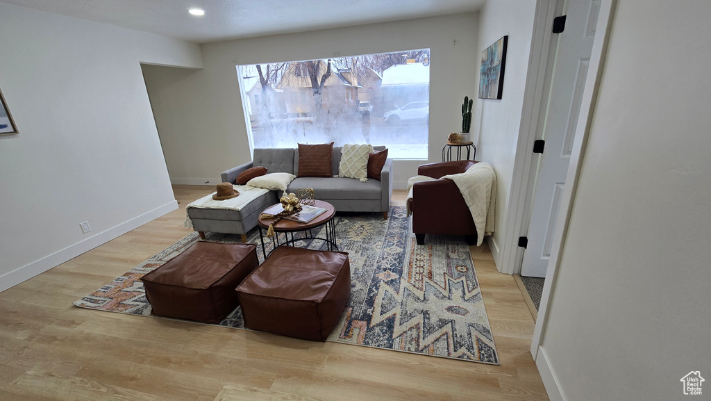 Living area featuring light wood-type flooring, baseboards, and recessed lighting