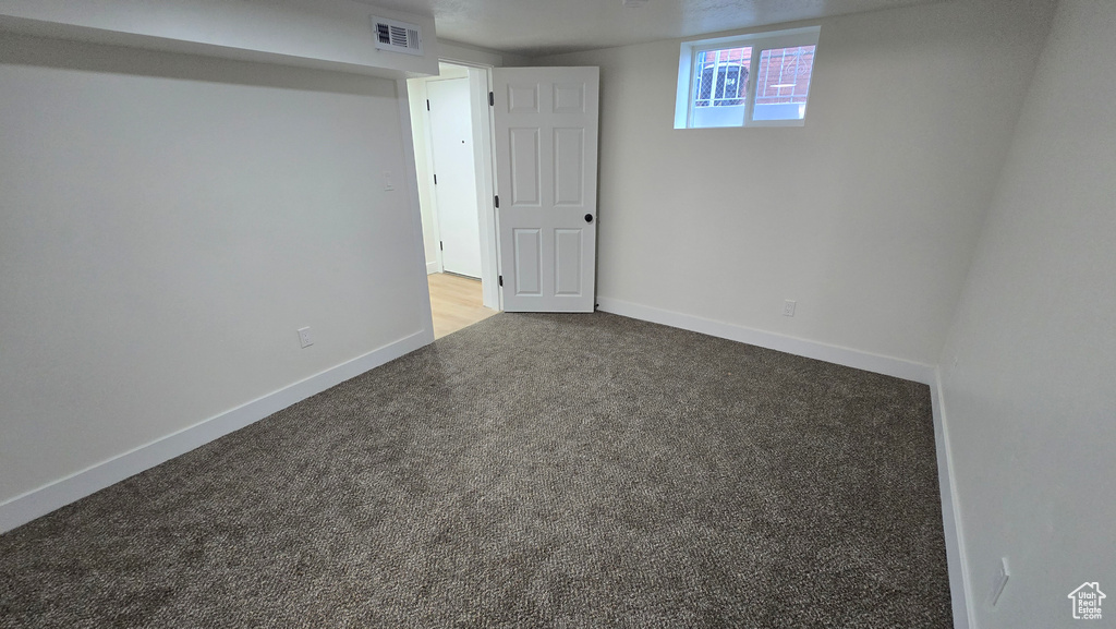 Interior space with baseboards, visible vents, and carpet flooring