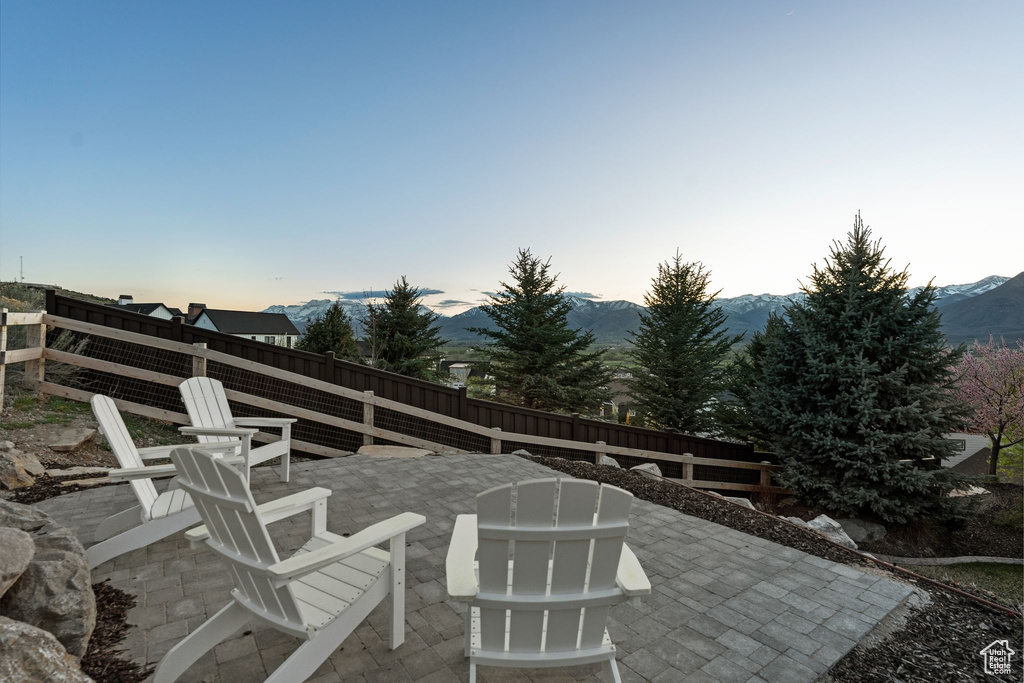 View of patio / terrace with a mountain view and a fenced backyard