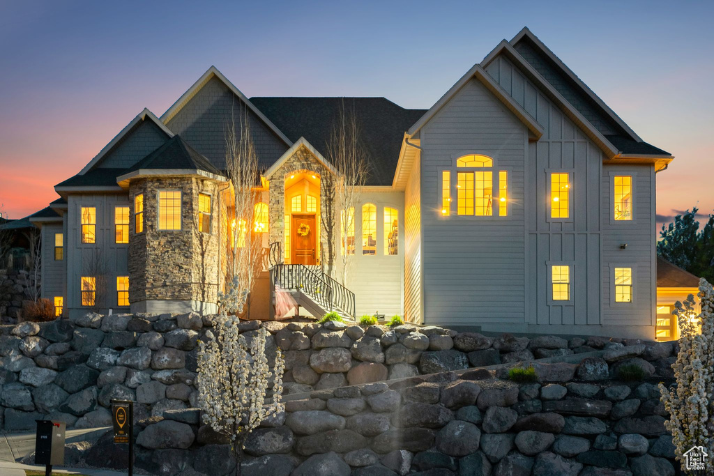 View of front of house featuring board and batten siding and stone siding
