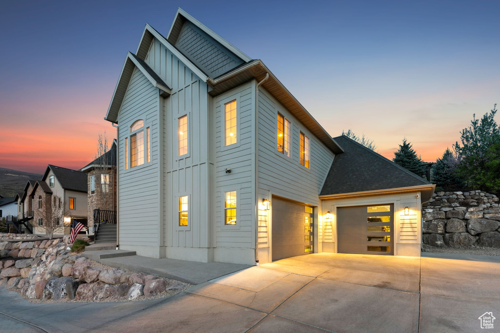 View of front of home featuring a garage, board and batten siding, and driveway