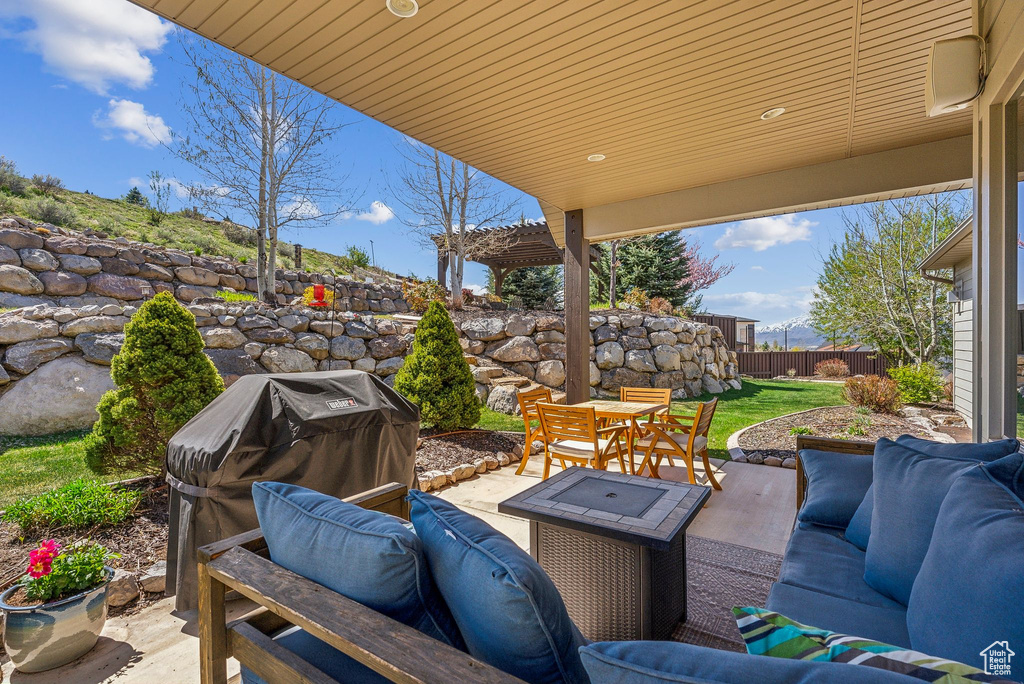 View of patio with an outdoor living space, fence, area for grilling, and outdoor dining space