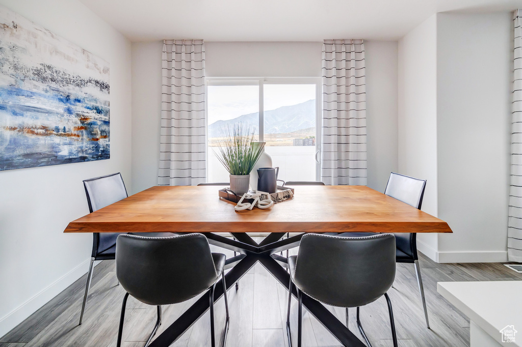 Dining area featuring baseboards, a mountain view, and wood finished floors