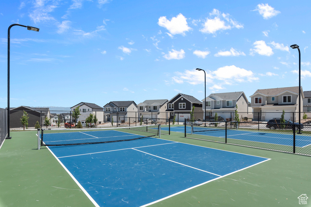 View of sport court with fence and a residential view