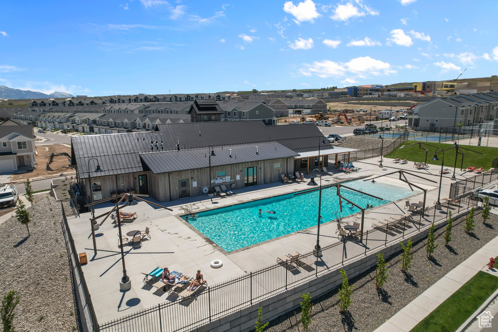 Pool featuring a residential view, a patio area, and fence