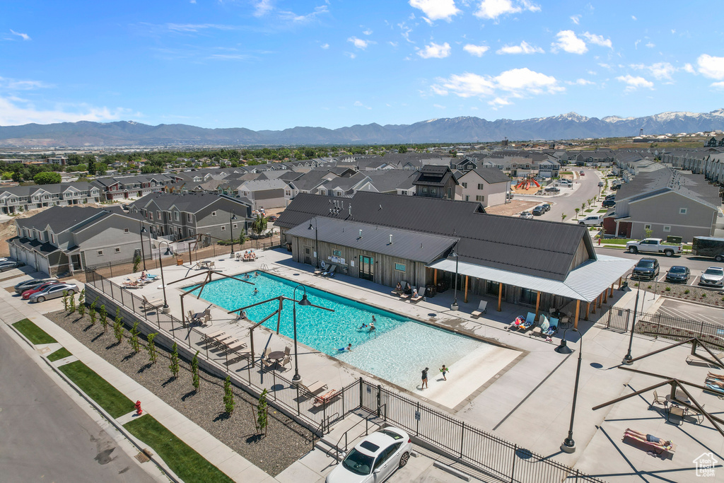 Pool featuring a residential view, a patio area, a mountain view, and fence