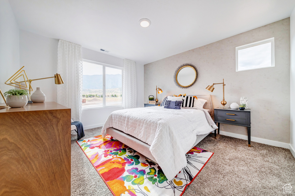 Bedroom featuring baseboards, visible vents, and carpet flooring