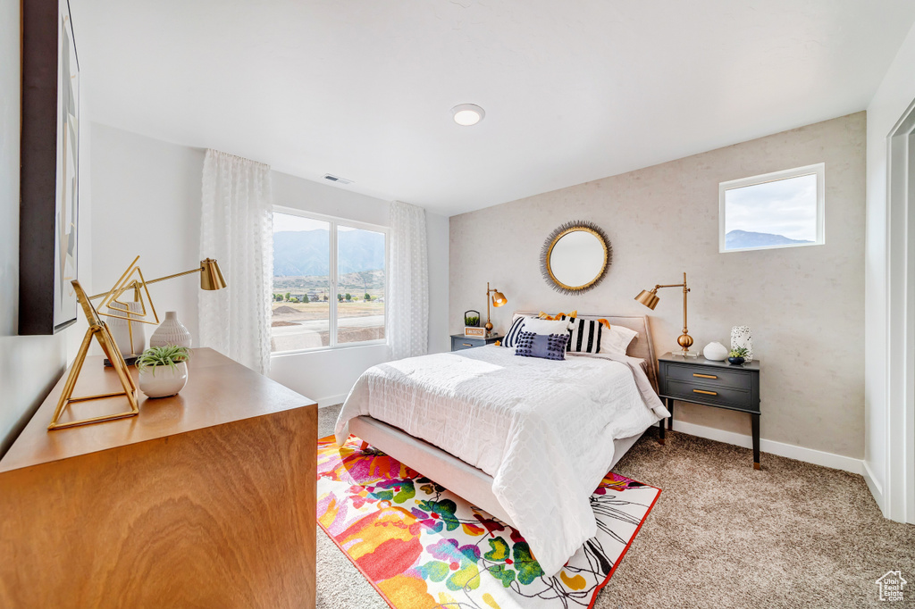 Carpeted bedroom with visible vents and baseboards
