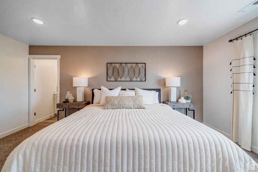 Carpeted bedroom featuring recessed lighting, visible vents, and baseboards