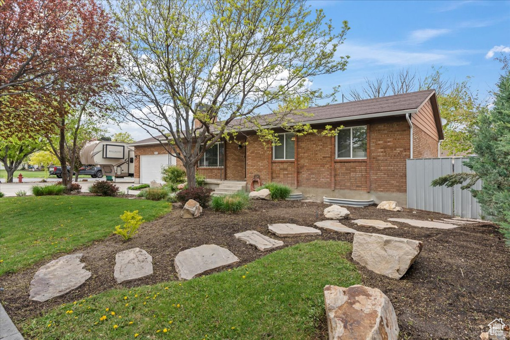 Ranch-style house featuring brick siding and a garage