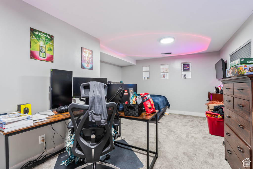 Carpeted office space with baseboards