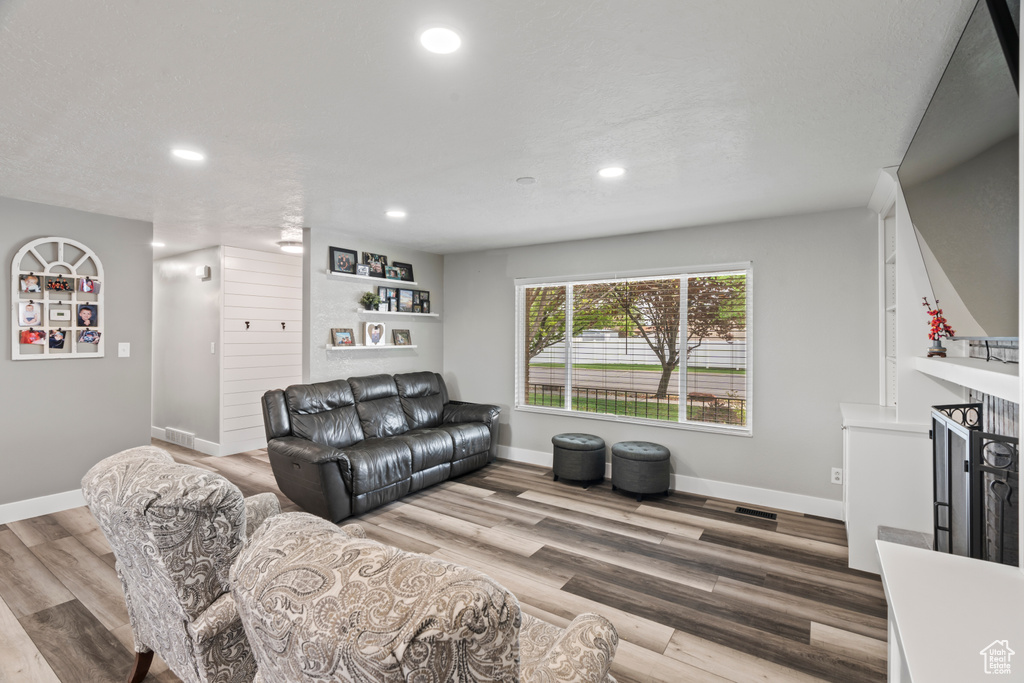 Living room featuring recessed lighting, baseboards, and wood finished floors