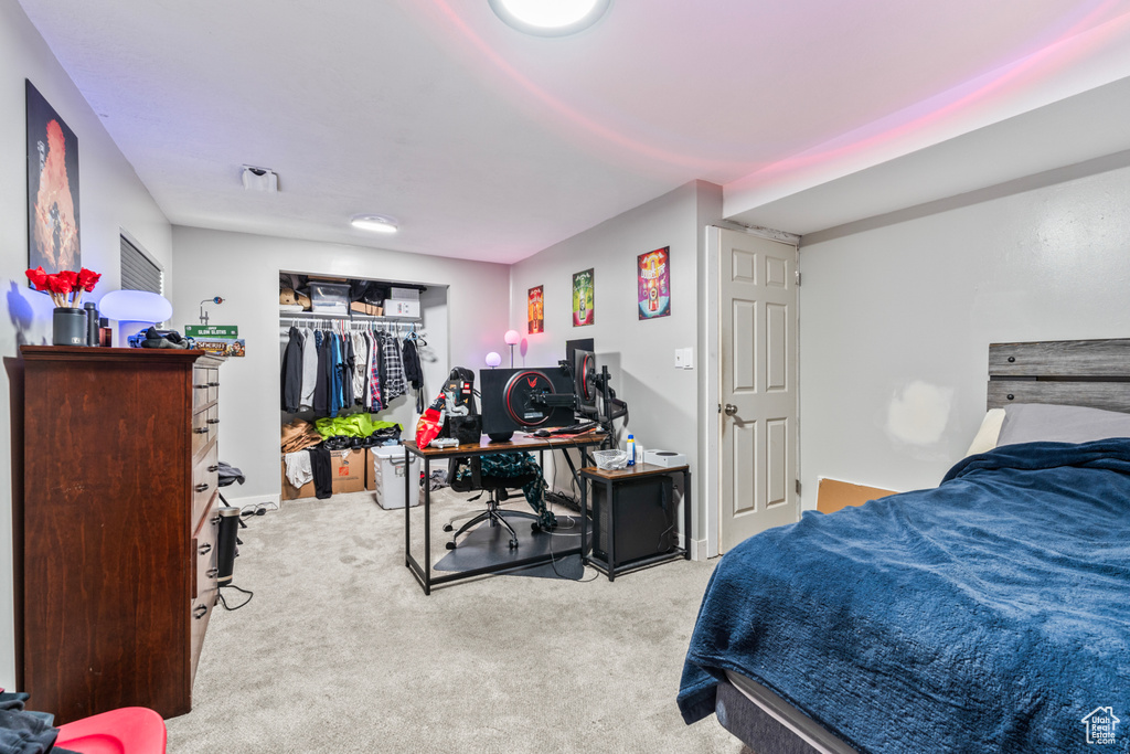 Bedroom featuring carpet, a desk, a closet, and baseboards