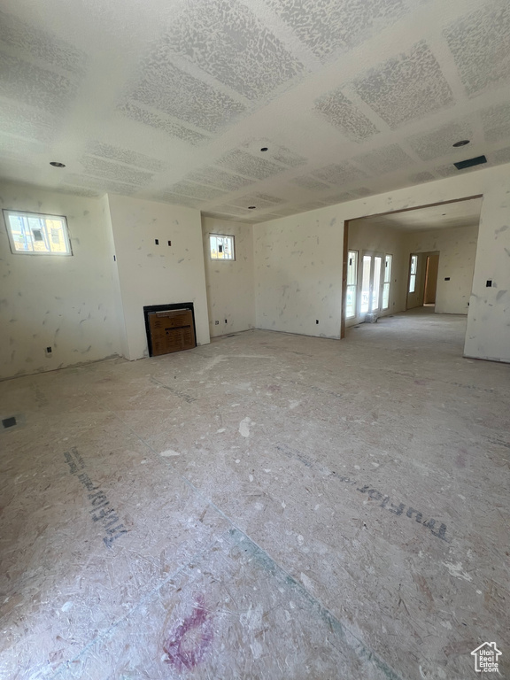 Unfurnished living room featuring plenty of natural light