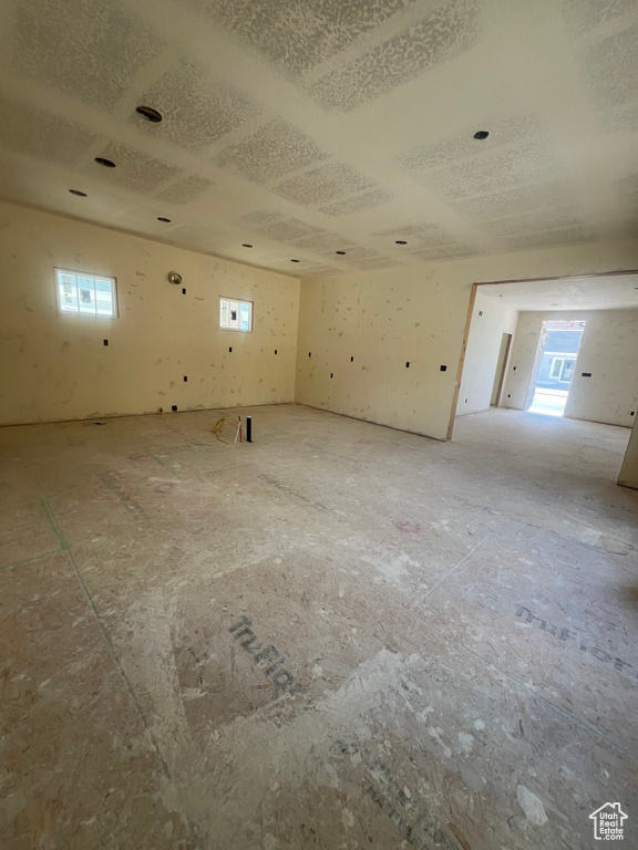 Unfurnished room featuring healthy amount of natural light and a textured ceiling