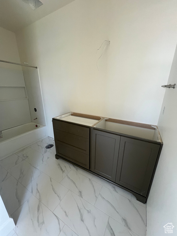 Full bath featuring marble finish flooring, shower / bathtub combination, and vanity