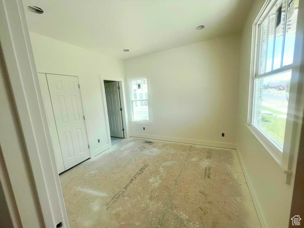 Unfurnished bedroom with multiple windows
