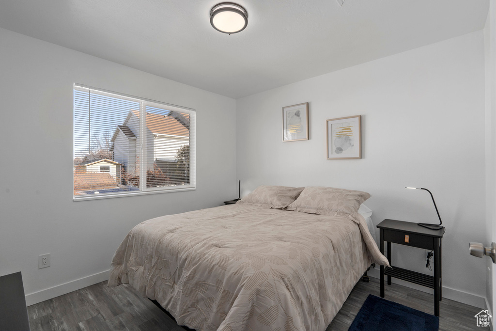 Bedroom featuring baseboards and wood finished floors