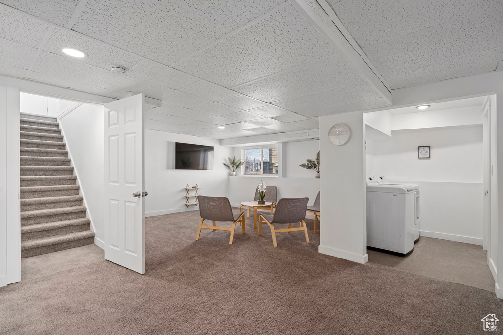 Interior space with stairs, carpet floors, washer / dryer, and baseboards