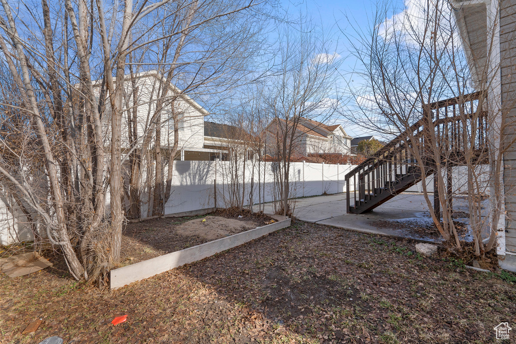 View of yard featuring stairway and fence