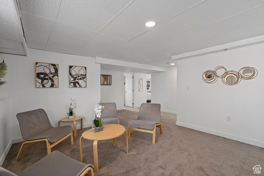 Living area with carpet floors, baseboards, and recessed lighting