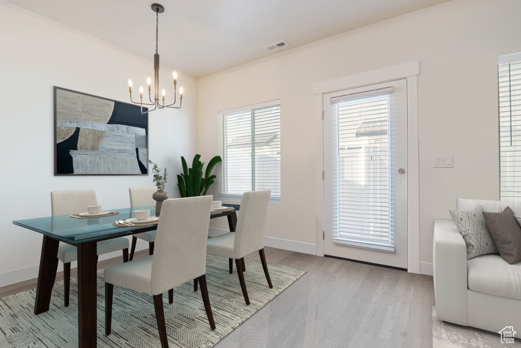 Dining space with a chandelier and light wood-style floors