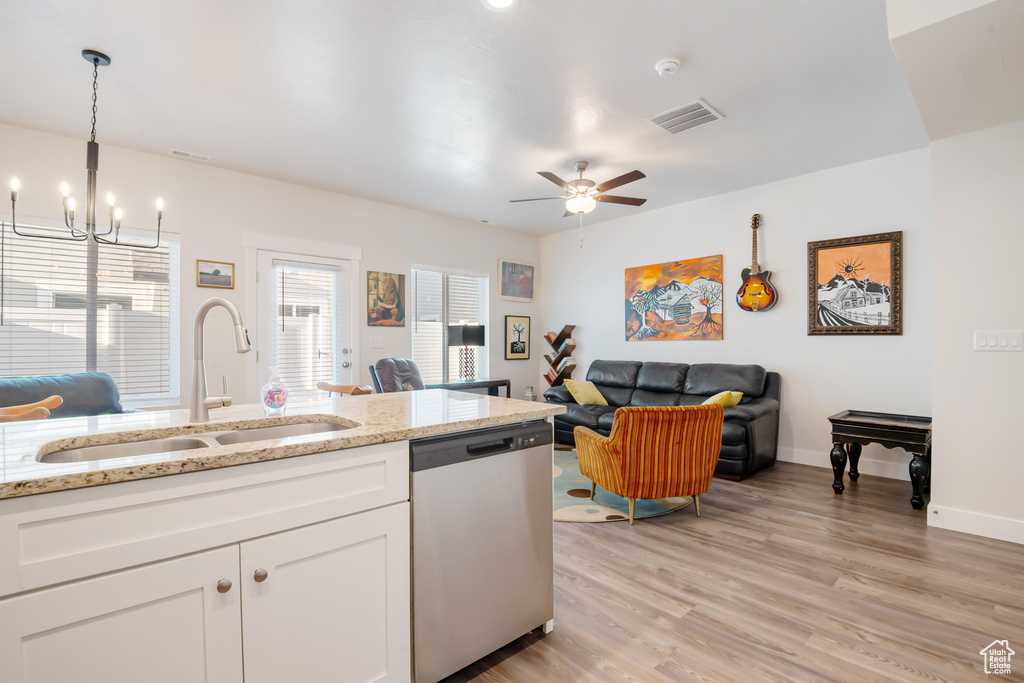 Kitchen with visible vents, dishwasher, light wood-type flooring, white cabinetry, and a sink